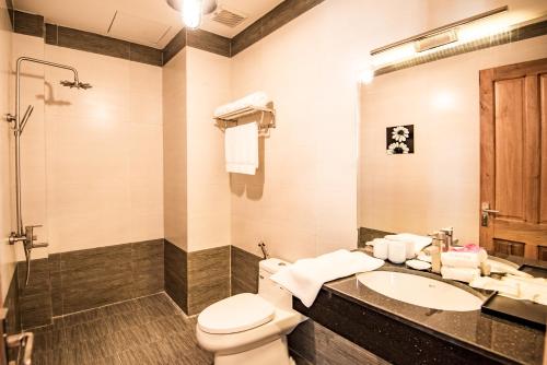 a bathroom with a toilet and a sink at Santa Sea Villa in Hoi An