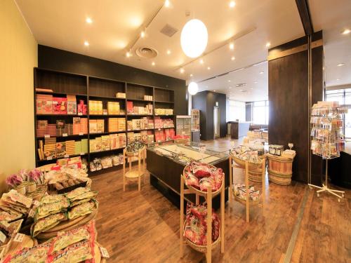 a store with tables and chairs in a room at Boso Shirahama Umisato Hotel in Minamiboso
