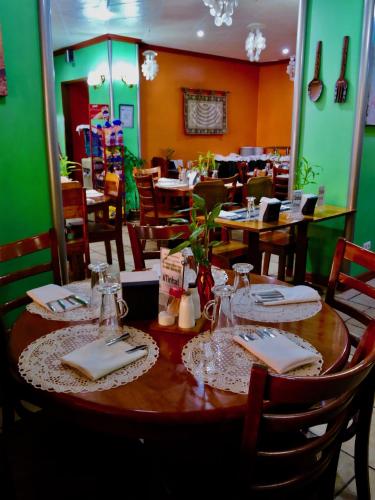a table in a restaurant with tables and chairs at TINHAT Halal حلال Certified Boutique Hotel And Restaurant in Davao City