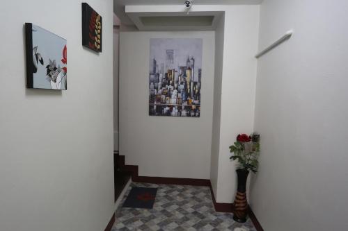 a hallway with a plant in a vase on the floor at TD Bangkok in Bangkok