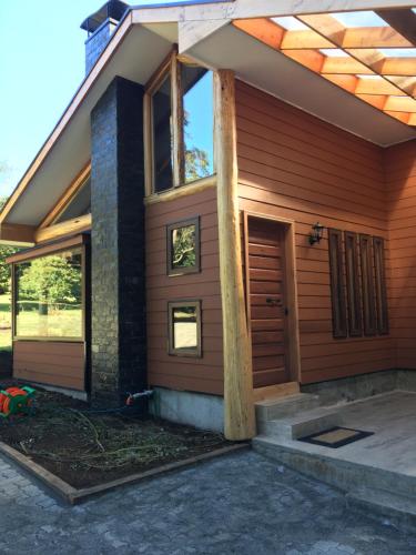 a house being constructed with the front door open at Cabañas Peumayen in Puerto Varas