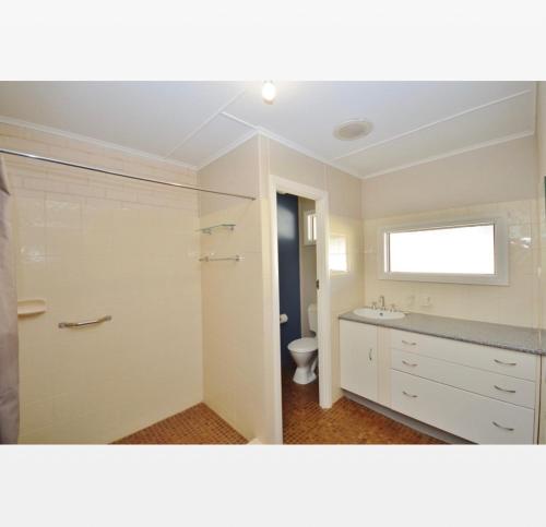 a bathroom with a toilet and a sink at Claire’s Place in Kalbarri