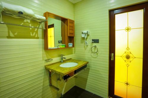 a bathroom with a sink and a mirror at Euro Star Hotel in Katunayake
