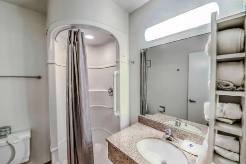 a bathroom with a sink and a shower and a mirror at Motel 6-Colorado Springs, CO in Colorado Springs