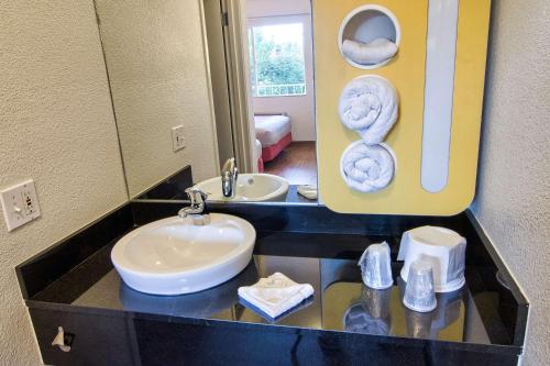 a bathroom with a sink and a mirror at Motel 6-Coeur D'Alene, ID in Coeur d'Alene
