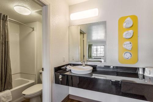 a bathroom with a sink and a toilet and a mirror at Motel 6-El Paso, TX - East in El Paso