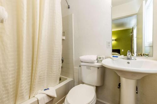 a bathroom with a toilet and a sink at Motel 6 San Rafael in San Rafael