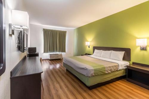 a hotel room with a bed and a television at Motel 6-North Richland Hills, TX - NE Fort Worth in North Richland Hills