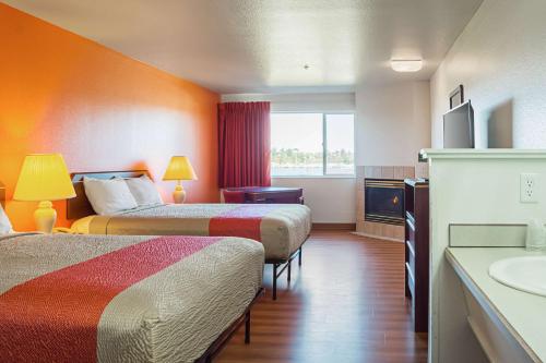 a hotel room with two beds and a sink at Motel 6-Newport, OR in Newport