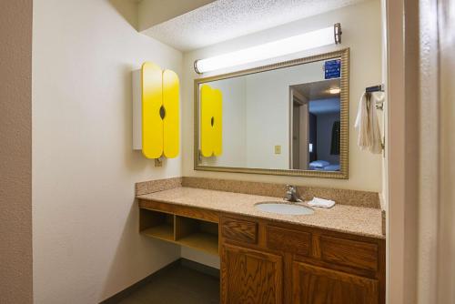 a bathroom with a sink and a mirror at Studio 6-Greensboro, NC in Greensboro