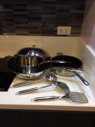 a pan and utensils sitting on a table at Hillary Timog Park Homes in Angeles