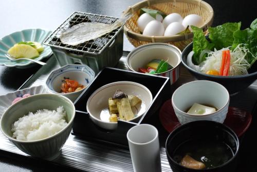 a tray with various bowls of food on a table at Biwako Hanakaido in Otsu