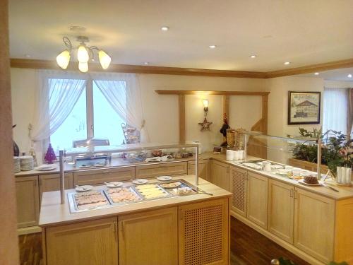 a large kitchen with a large island in a room at Hotel Wagner in Obertauern