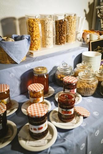 a table filled with jars of food on plates at Hotel Römerhof in Leukerbad