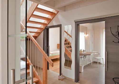 a hallway with a staircase and a room with a table at Erlebnis-Käse-Wohlfühl-Hof in Röckingen