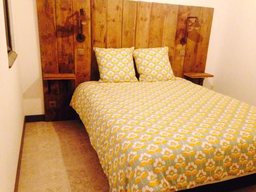 a bedroom with a bed with a wooden headboard at Baiona in Bayonne