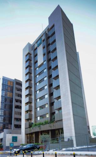 a tall building with a car parked in front of it at Citea Apart Hotel in Beirut