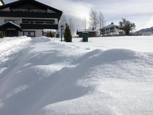 a pile of snow in front of a house at Bran Monte Crai Chalet in Bran