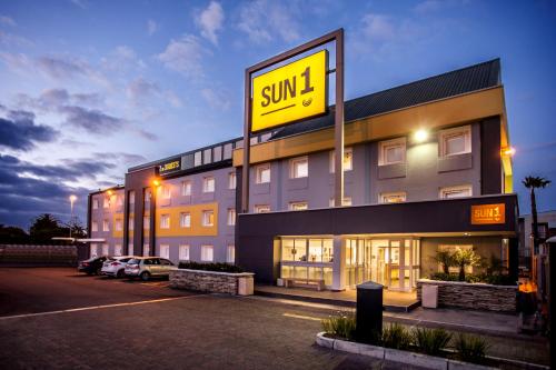 a large building with a sign that reads sun inn at SUN1 MILNERTON in Cape Town