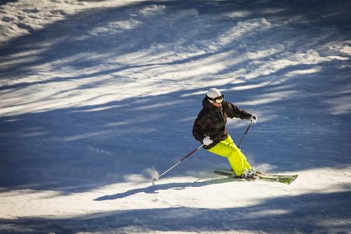 a person is skiing down a snow covered slope at Bran Monte Crai Chalet in Bran