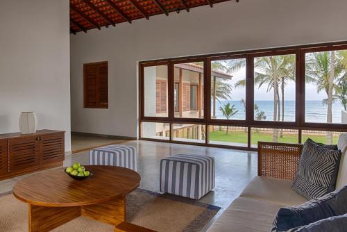 a living room with a couch and a table at Jetwing Villa 700 in Bentota