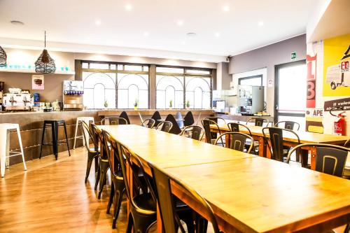 a dining room with tables and chairs in a restaurant at Hostel Trastevere in Rome