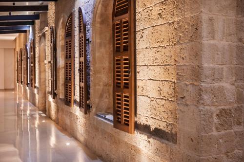a row of windows on the wall of a building at The Setai Tel Aviv, a Member of the leading hotels of the world in Tel Aviv