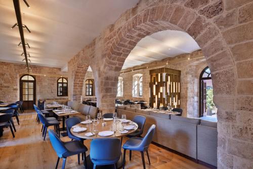 a restaurant with brick walls and tables and chairs at The Setai Tel Aviv, a Member of the leading hotels of the world in Tel Aviv