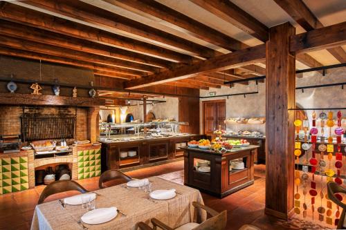 a large kitchen with tables and chairs in a room at Hotel Cala del Pi - Adults Only in Platja  d'Aro