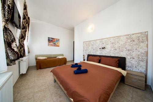 Un dormitorio con una cama grande con almohadas azules. en Boul Rosu Residence en Arad