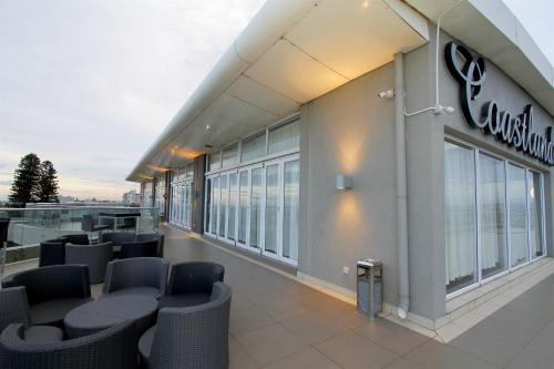 a view of the outside of a building with chairs at Coastlands Musgrave Hotel in Durban