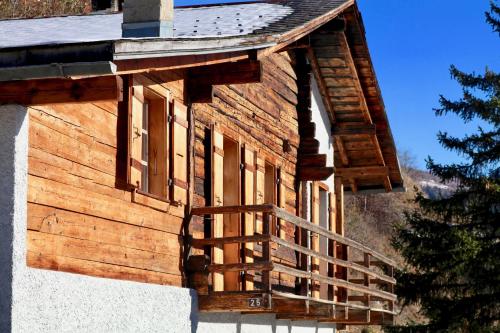 a wooden building with a staircase on the side of it at Magnifique chalet pour 10 personnes à Vercorin in Vercorin