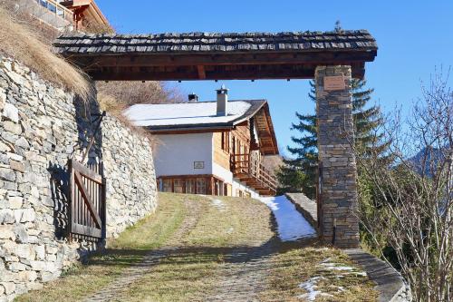 an entrance to a stone building with a gate at Magnifique chalet pour 10 personnes à Vercorin in Vercorin