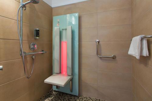a shower with a glass door in a bathroom at Hotel Kongress in Leoben