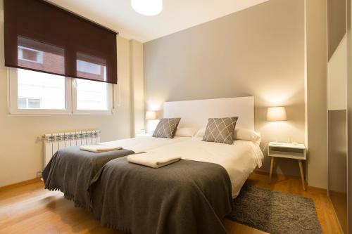 A bed or beds in a room at Granada Home Centro
