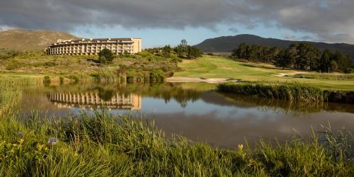 a hotel on a hill next to a lake at Arabella Hotel, Golf and Spa in Kleinmond