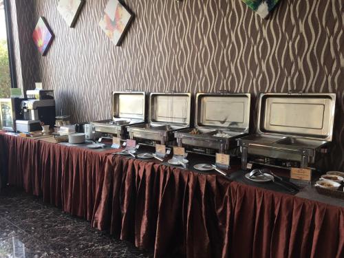 a table with five monitors on top of it at The Proud Hotel in Ubon Ratchathani