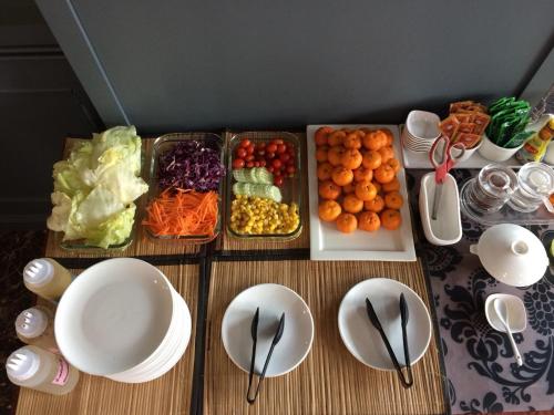a table topped with plates and bowls of food at The Proud Hotel in Ubon Ratchathani