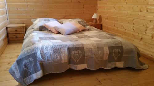 ein Bett mit zwei Kissen darauf in einer Hütte in der Unterkunft La cabane du pommier in Orelle