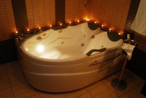 a bath tub with lights around it in a bathroom at Asteras Hotel in Naousa