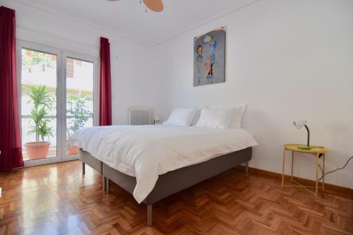 a bedroom with a large bed and a wooden floor at Athens central apartment with Acropolis views! - SQ1 in Athens