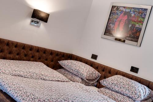 a bedroom with a bed with pillows on it at Tom Thumb Apartments in Liverpool