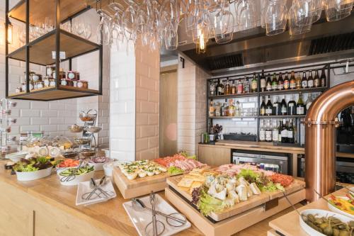 a buffet with many different types of food on display at Smart Hotel in Gdańsk