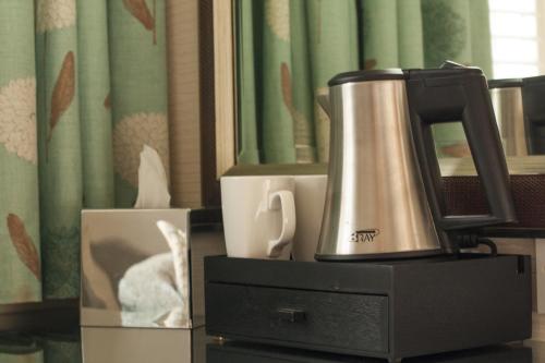a coffee maker sitting on top of a dresser at Ascot House in Harrogate