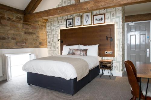 A bed or beds in a room at The Kestrel by Innkeeper's Collection