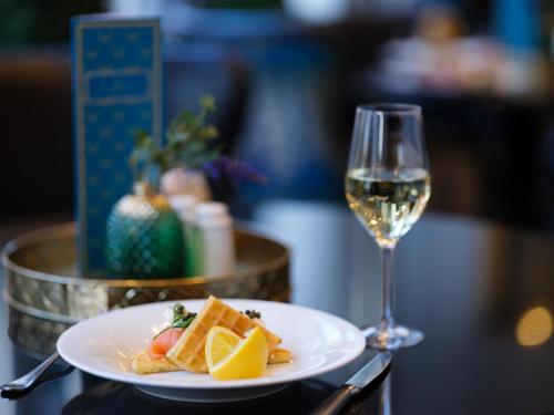 a plate of food and a glass of wine at The Chester Grosvenor in Chester