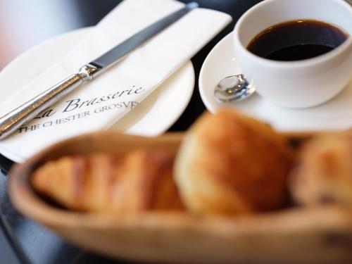 a cup of coffee and a bowl of bread at The Chester Grosvenor in Chester