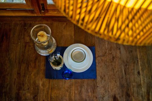 a table with a cup of coffee and a plate of food at Cozycomo Chiang Dao - Wiang Mek in Chiang Dao