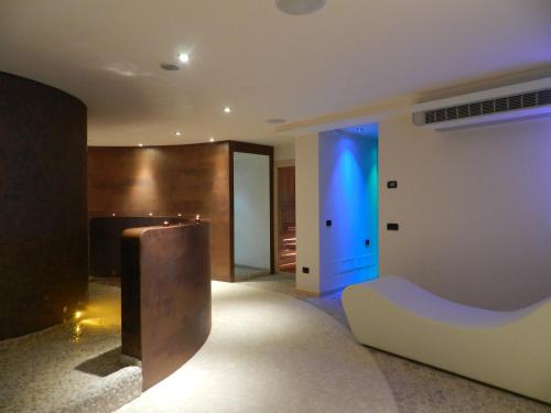 a living room with a couch and a blue light at Residence Hotel Raggio Di Luce in Ponte di Legno