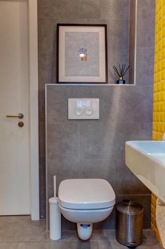 a bathroom with a white toilet and a sink at First Hostel in Bucharest